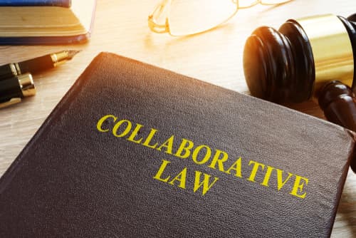 Collaborative Law book on table with gavel and glasses