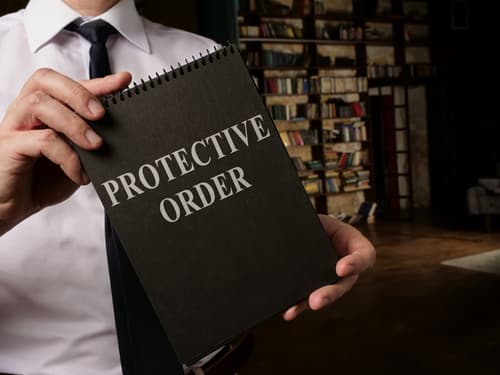 lawyer holding protective order notepad