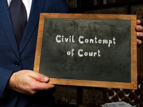 person holding chalkboard civil contempt of court sign