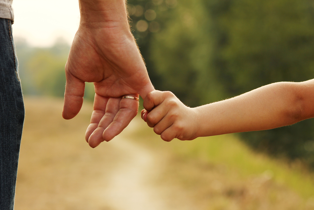 Father Holding Child's Hand