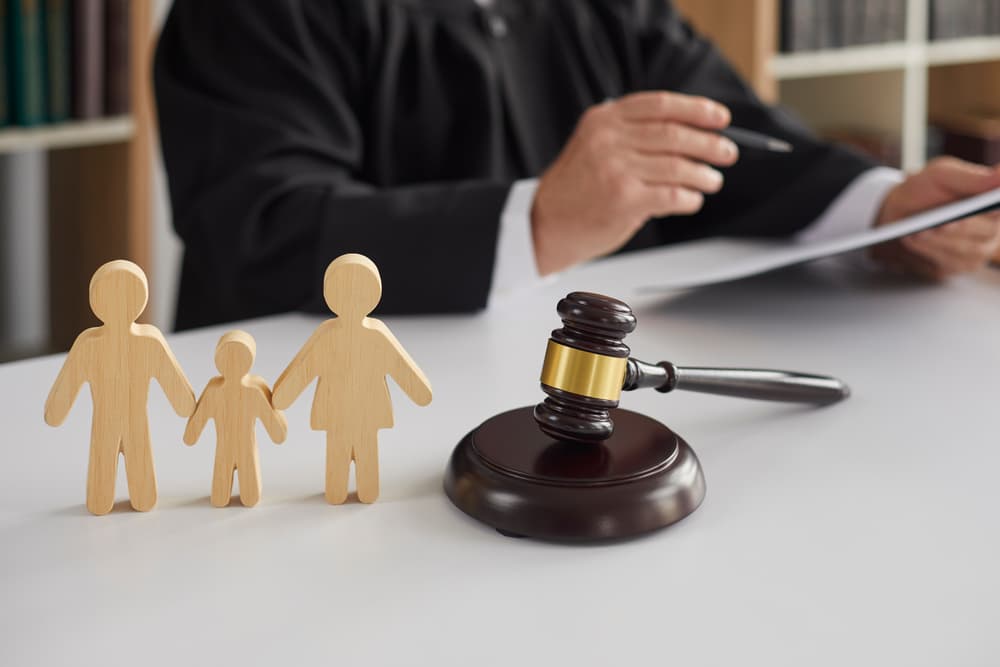 A judge is seen conducting a divorce proceeding, with a gavel prominently displayed. The scene embodies the concepts of alimony, family law, and child custody.