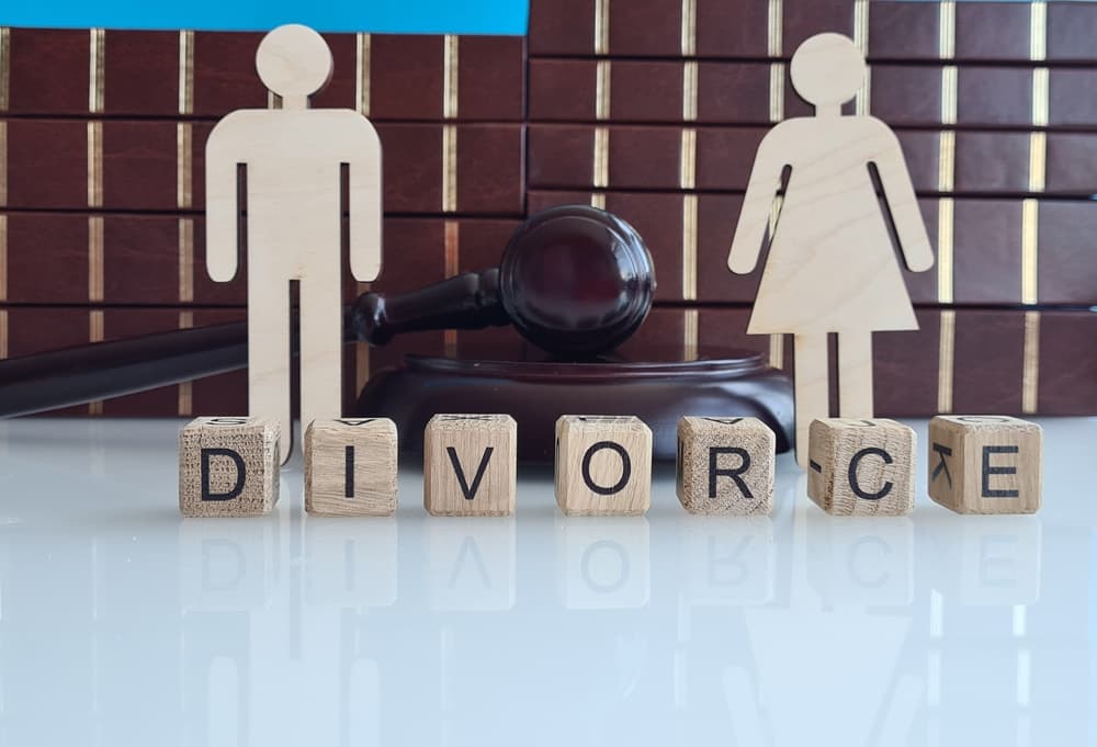 Wooden Blocks Spelling Divorce With Gavel and Couple Figures