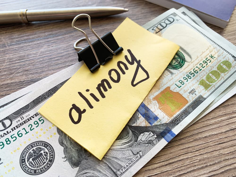 Payments alimony. Pile Dollars with sign alimony and money. Divorce and separation concept