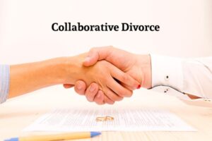 A man and woman shaking hand after signing collaborative Divorce