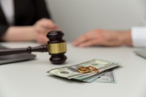 Closeup view of wooden gavel and money.