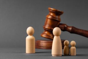Wooden toy family and and Judge's gavel. Child Custody Concept
