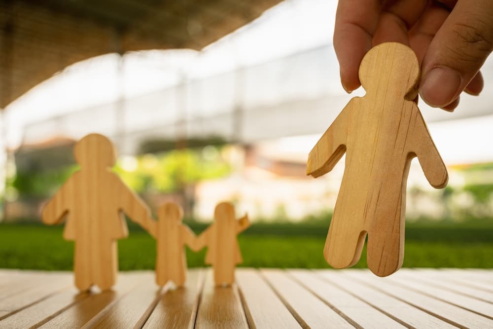 A family symbol showing a father, mother, and child, with a mysterious hand pulling the father away