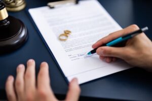 signing a divorce agreement document.