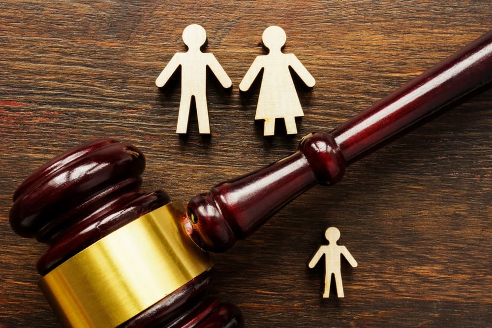 Family figures and gavel. Concept of Child Custody Determination