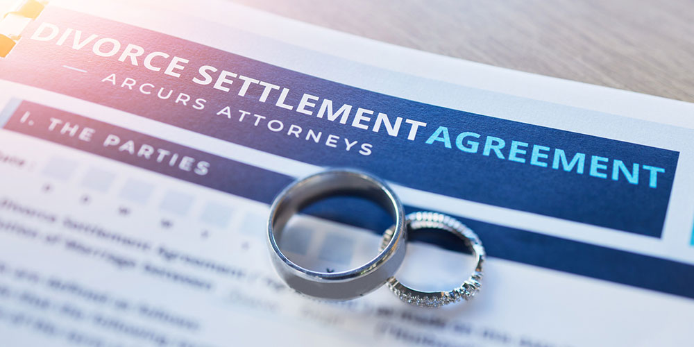 Divorce agreement paperwork and wedding ring concept image, representing complex property division and high-asset divorce representation in Barrington